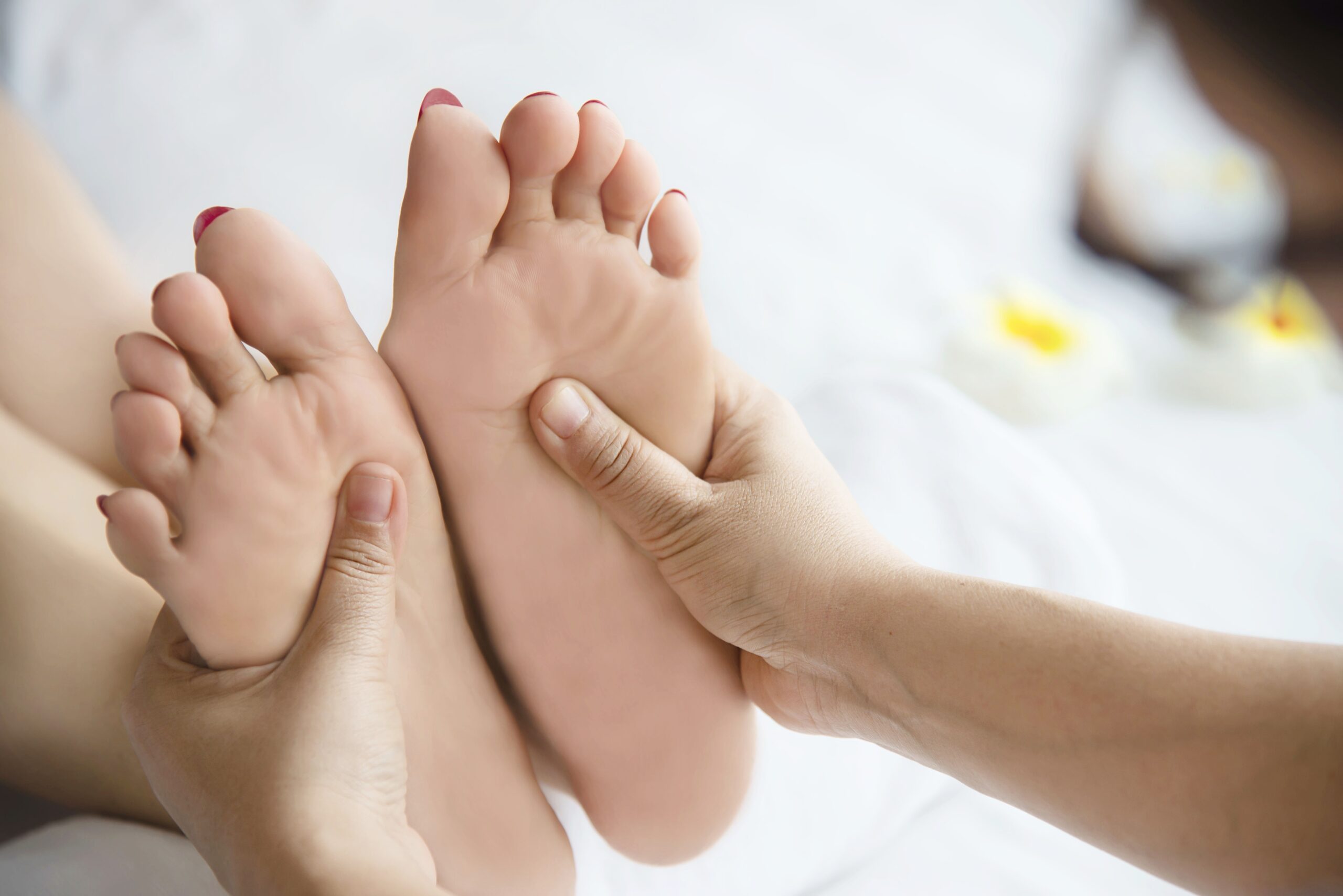 woman receiving foot massage service from masseuse close up hand foot relax foot massage therapy service concept